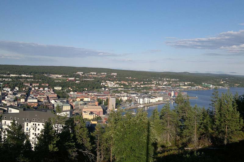 Umeå centrum med älven i förgrunden och kvällsljus över staden